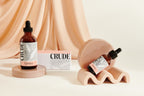 A bottle of CRUDE's 4oz Cleanse next to a smaller 1oz Cleanse bottle
